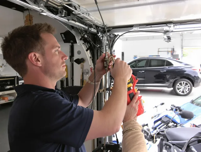 Maynard Garage Door Repair safety certified technician performing cable replacement in Maynard